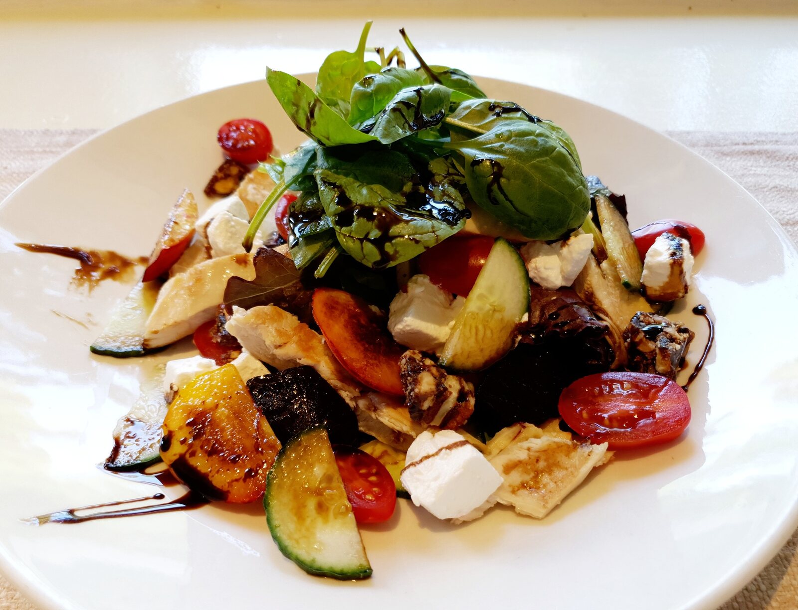 Grilled nectarine salad with greens, feta and toasted nuts