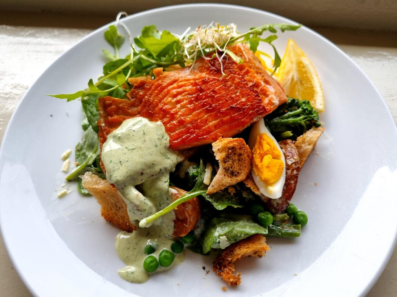 Smoked trout Caesar salad with greens and egg